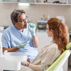 Doctor talking to patient about oral cancer symptoms