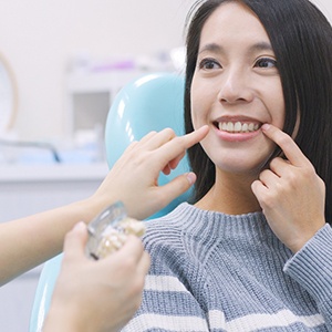 A woman pointing to her tooth
