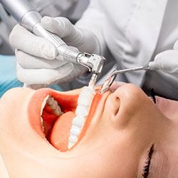 Woman receiving professional teeth cleaning