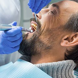 Man receiving professional teeth cleaning