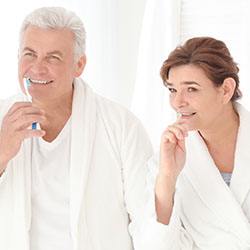 Senior couple brushing teeth together