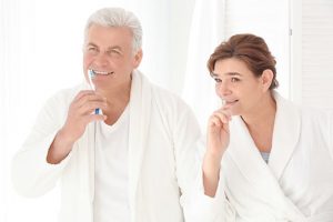 mature couple brushing teeth